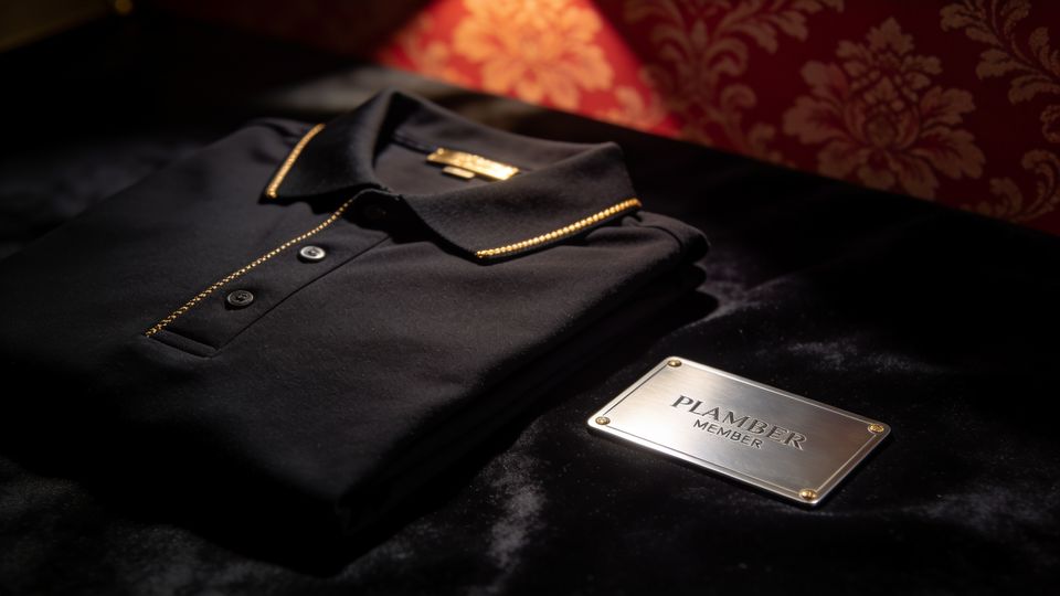 A platinum-thread black polo beside a platinum member card
